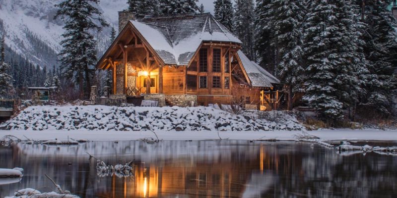 cabin reflecting in the water in winter