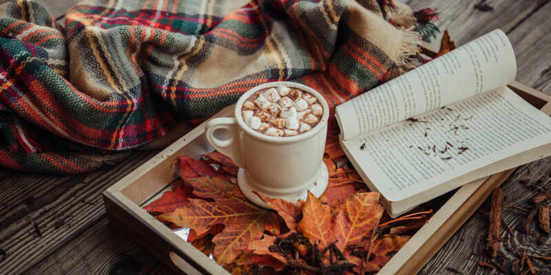 photo of hot cocoa and a book