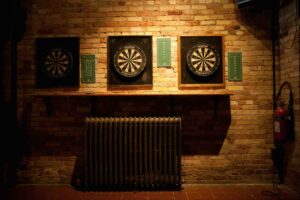 a brick wall with three dart boards