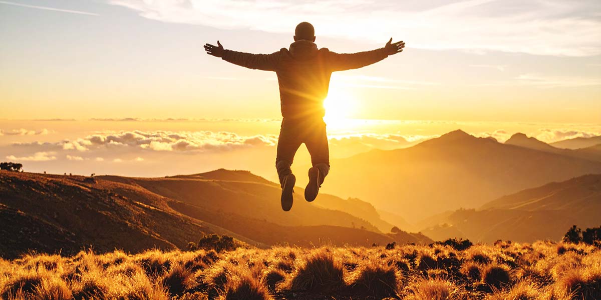 floating - Low Two Pair A lone person floating gently above the ground in a golden sunrise landscape, defying gravity but not afraid.