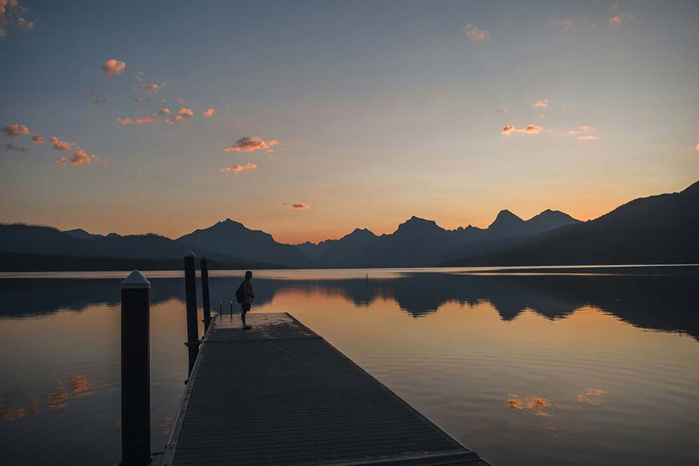 dock - Low Two Pair a solitary person standing on a dock at sunrise