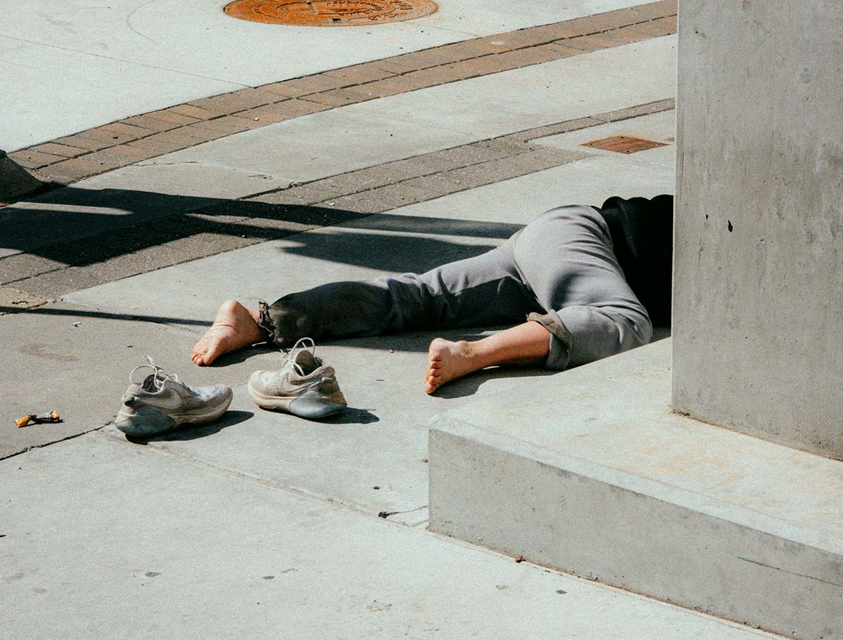 fall - Low Two Pair a person laying facedown on the concrete with shoes off