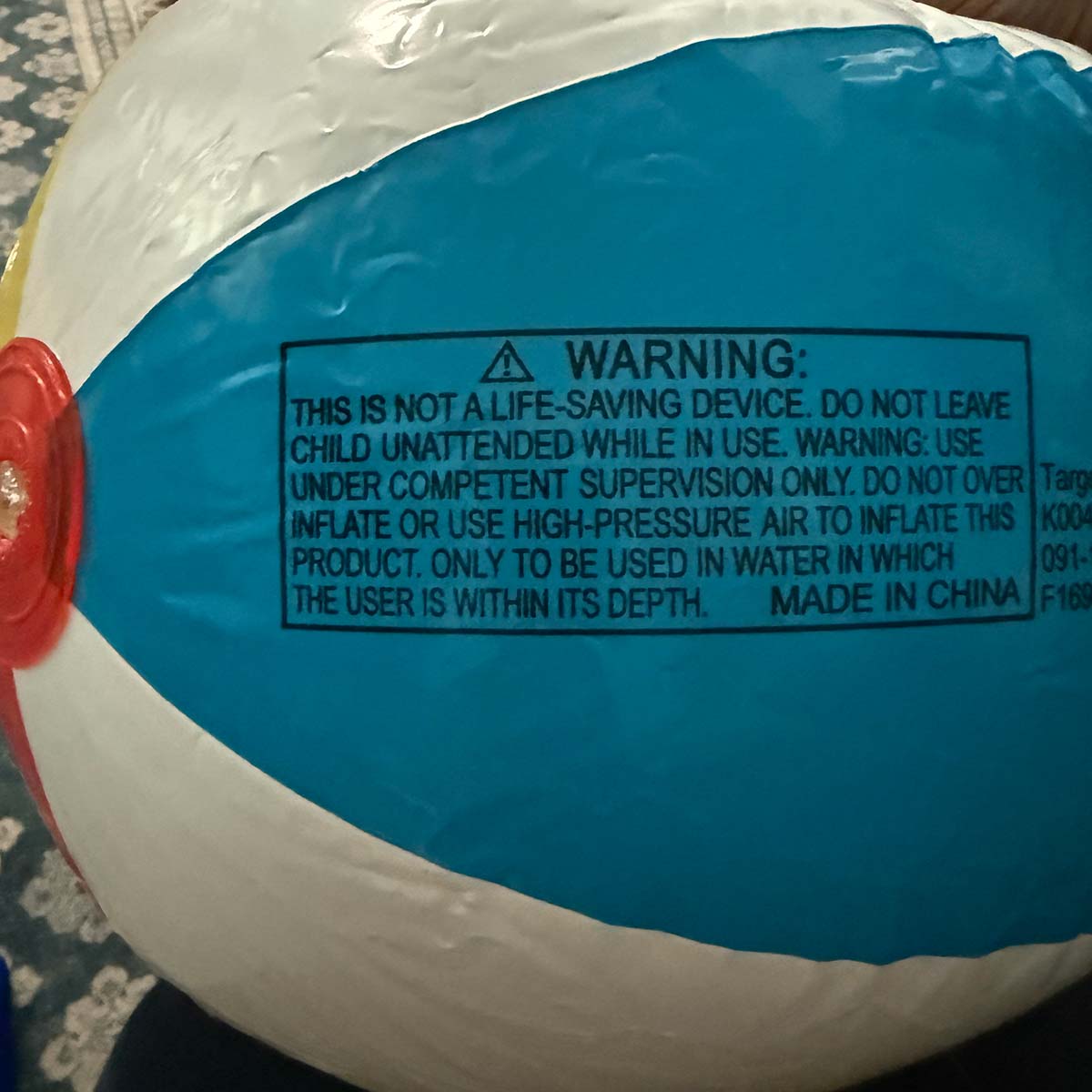 beach-ball - Low Two Pair a beach ball with a warning label