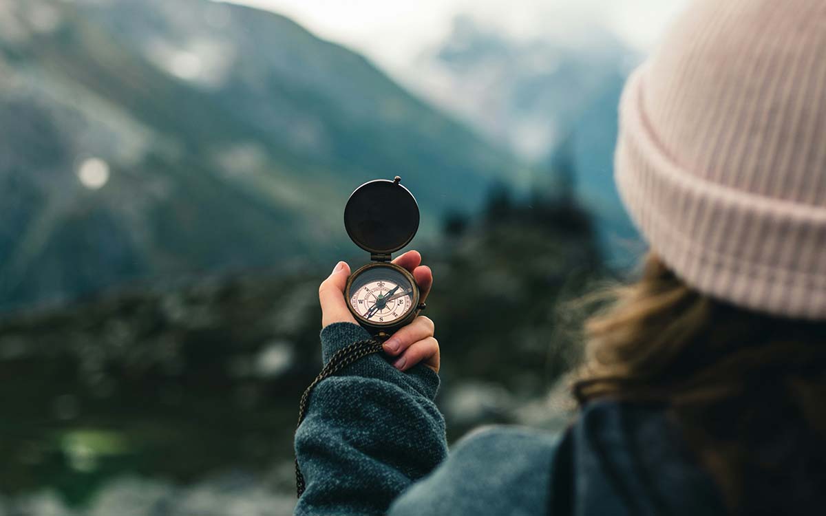 a woman holding a compass