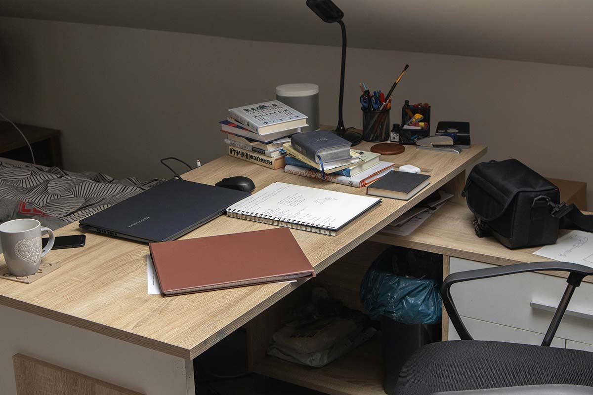dirty-desk - Low Two Pair A cluttered study filled with books, papers, and coffee mugs, symbolizing the unseen work behind success.