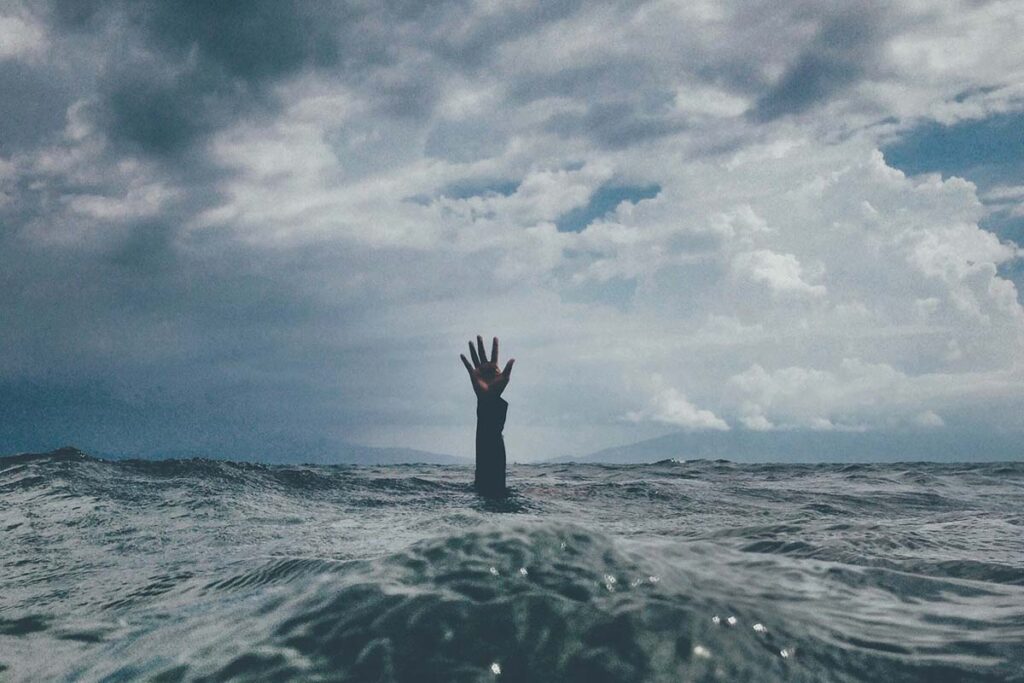 drowning5d8f7ef397744b8b8ab89ae93ac8bb1a - Low Two Pair a hand sticking out of the water, a person drowning.