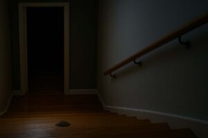 A staircase in low light with a hidden obstacle, symbolizing how small surprises can derail your morning.