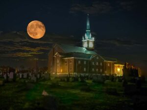 a churchyard under a full moon at night