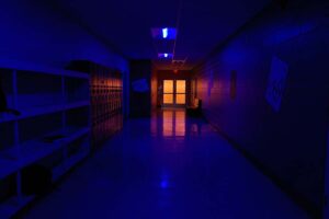 creepy hallway with a light behind a door