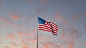 An American flag waving in morning light, symbolizing remembrance, gratitude, and hope on Veterans Day.”