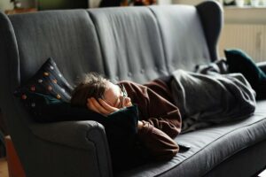 a person sleep on the couch taking a nap