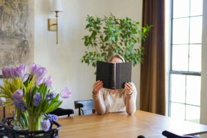 a women enjoy a book in a sunlit kitchen