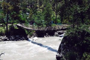 a rickety bridge over a raging river