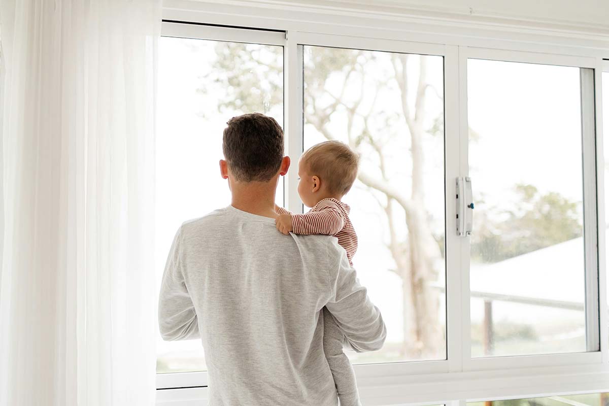 a parent and a child looking out a window
